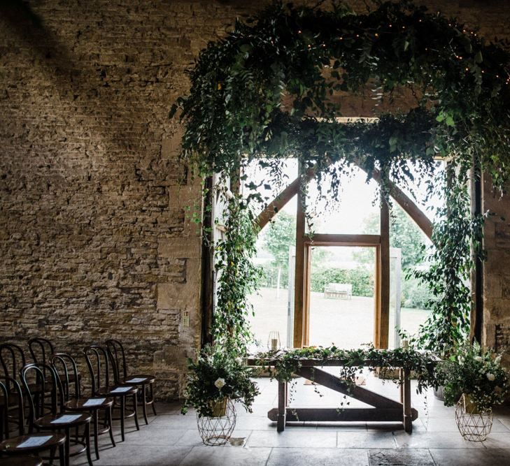 Cripps Stone Barn Ceremony Room with Greenery Decor by Go Wild Flowers