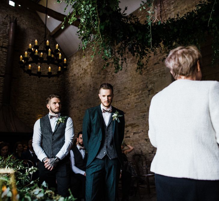 Groom Standing at the Altar in a Wool Waistcoat and Floral Bow Tie