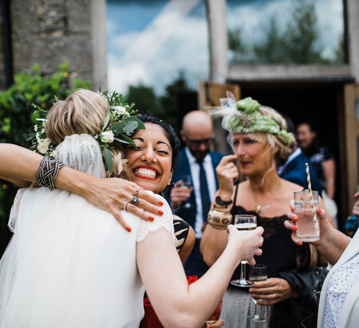 Bride being Embraced by Wedding Guests