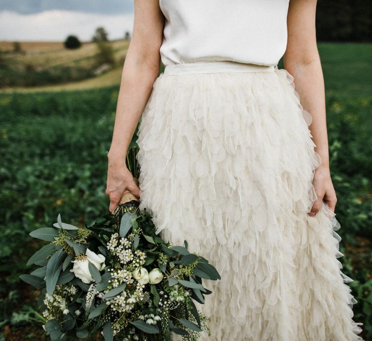 Bride in Stylish Halfpenny London Swan Tulle Petal Skirt Holding a White and Green Bouquet