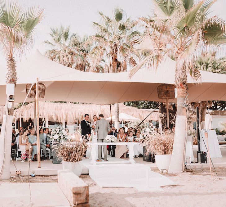 Wedding Ceremony | Bride in Yaki Ravid Gown | Groom in Armani Suit | Blush Pink &amp; White Marbella Beach Wedding at El Chiringuito, Puente Romano |  Kino Ortega Photographer