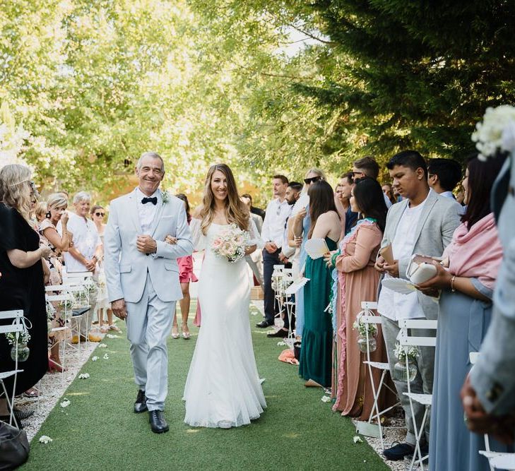 Bride at Provence Wedding in off the shoulder dress walking down to the aisle