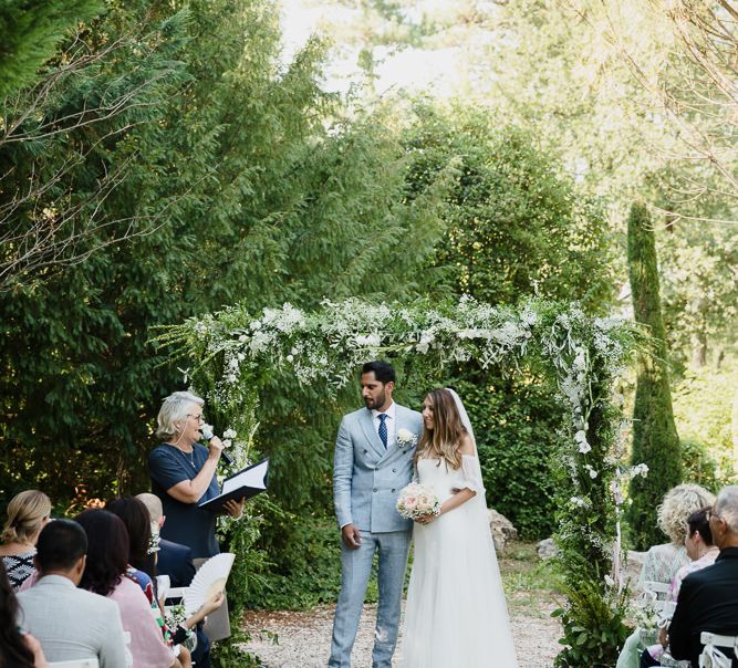 Bride and groom with celebrant at an outdoor wedding