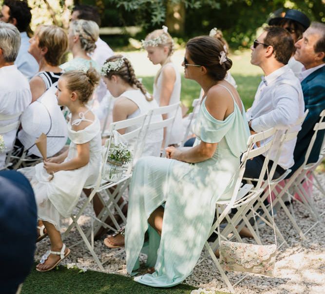 Guests sat on chairs at outdoor wedding