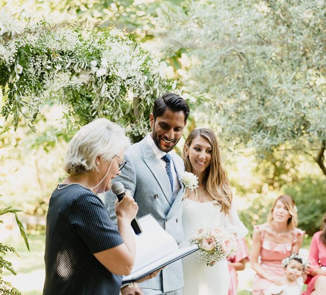 Bride and groom with celebrant at an outdoor wedding in Provence