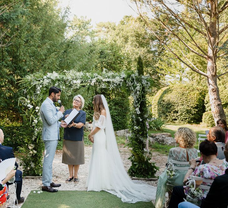 Bride and groom with celebrant at an outdoor wedding in Provence