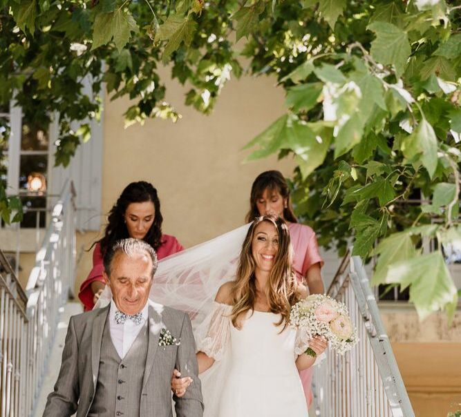 Bride at Provence Wedding in off the shoulder dress walking down to the aisle