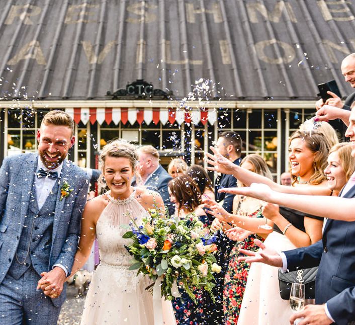 Confetti Moment | Bride in Halterneck Tulle Allure Bridal Wedding Dress | Groom in  Blue Check Moss Bros. Suit | Vintage Fairground at Blists Hill Victorian Town Museum in Ironbridge | Lisa Carpenter Photographer