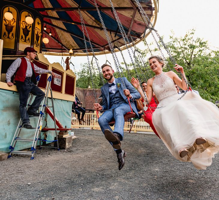 Fairground Swing Ride | Bride in Halterneck Tulle Allure Bridal Wedding Dress | Groom in  Blue Check Moss Bros. Suit | Vintage Fairground at Blists Hill Victorian Town Museum in Ironbridge | Lisa Carpenter Photographer