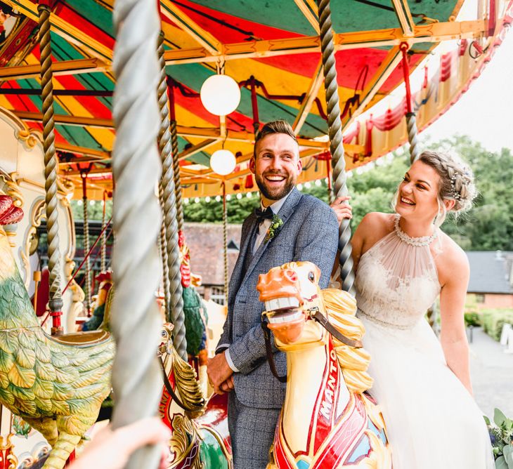 Carousel Ride | Bride in Halterneck Tulle Allure Bridal Wedding Dress | Groom in  Blue Check Moss Bros. Suit | Vintage Fairground at Blists Hill Victorian Town Museum in Ironbridge | Lisa Carpenter Photographer