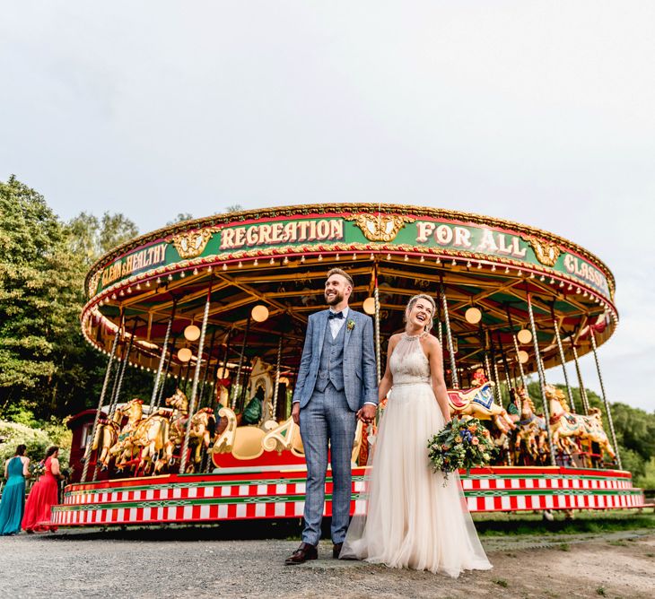 Vintage Carousel | Bride in Halterneck Tulle Allure Bridal Wedding Dress | Groom in  Blue Check Moss Bros. Suit | Vintage Fairground at Blists Hill Victorian Town Museum in Ironbridge | Lisa Carpenter Photographer