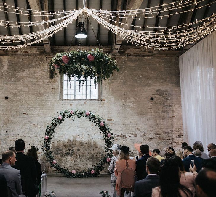 Ceremony Altar with Floral Moon Gate, Drapes and String Lights Wedding Decor