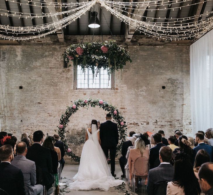 Bride and Groom at the Moon Gate Altar with Drapes and Fairylights