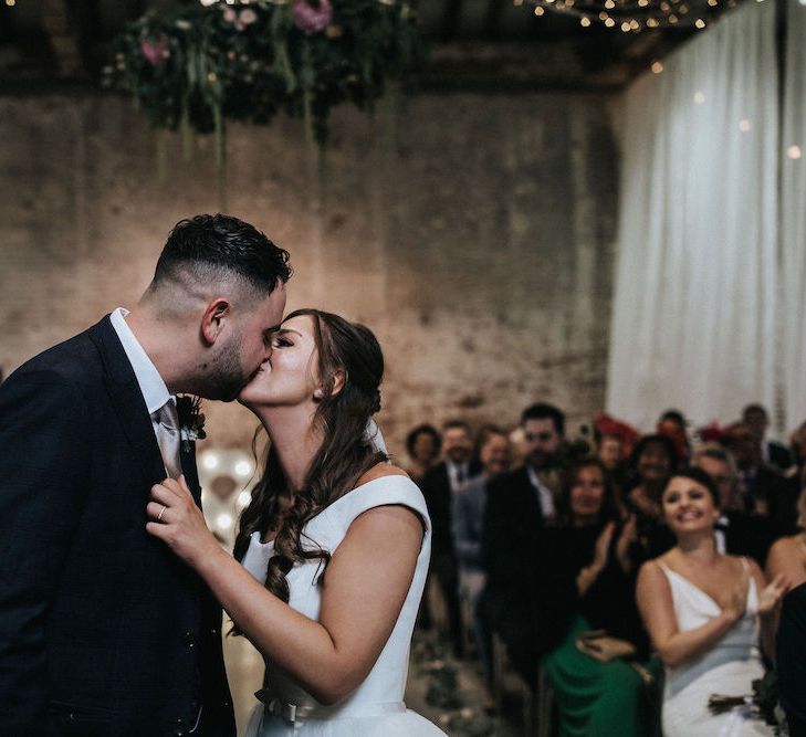 Bride and Groom Kissing during the Wedding Ceremony