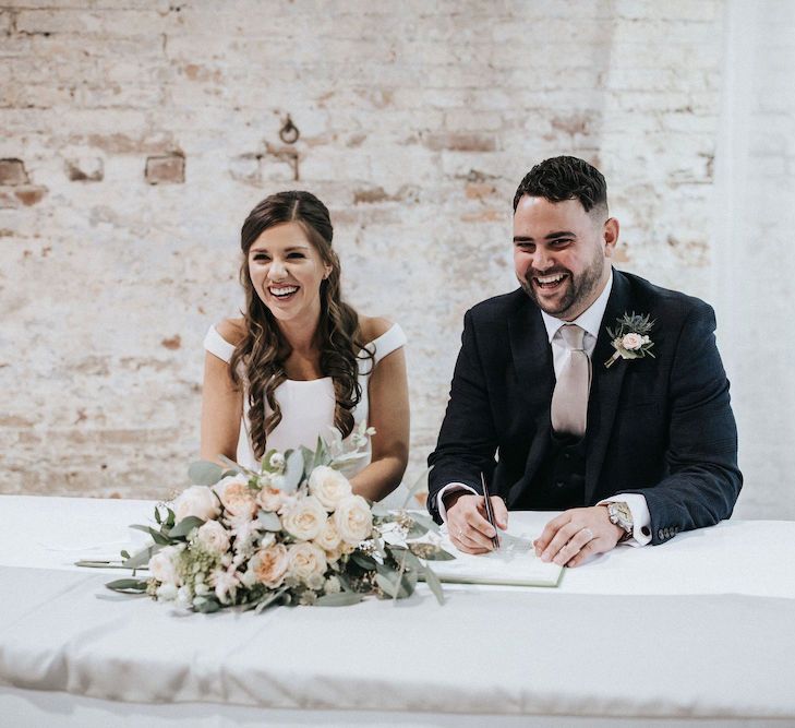 Bride and Groom Signing the Register