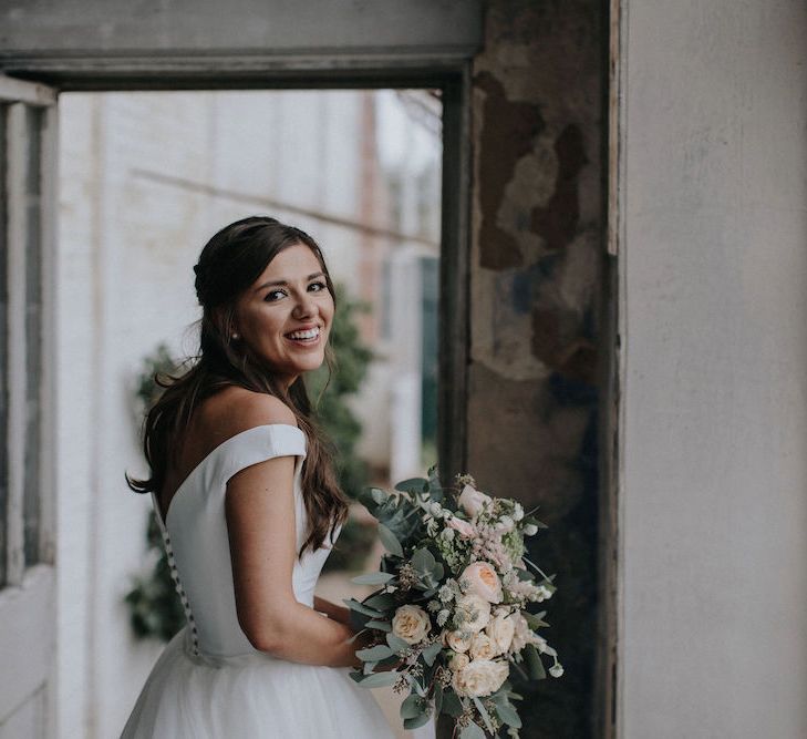 Beautiful Bride in Off the Shoulder Suzanne Neville Gown  and Wedding Bouquet