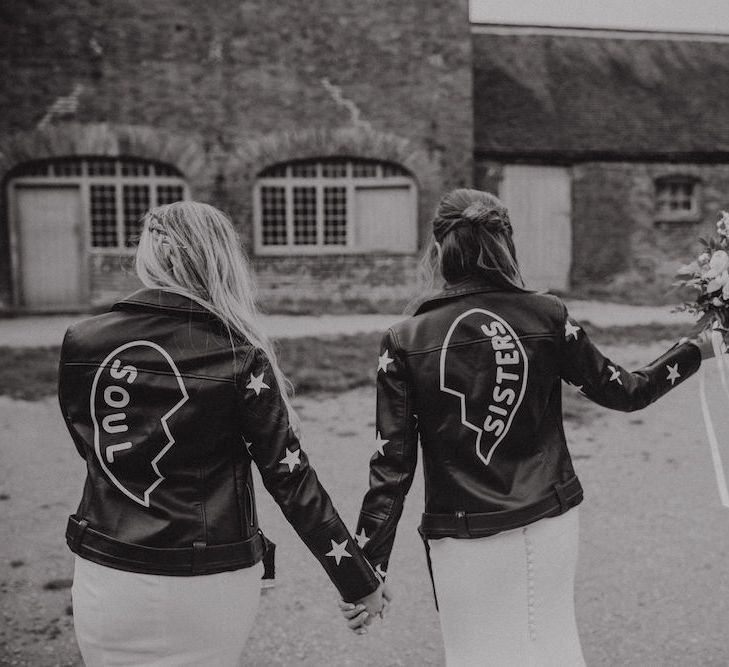 Bride and Bridesmaid in Leather Jackets with Soul Sister Written on the Back