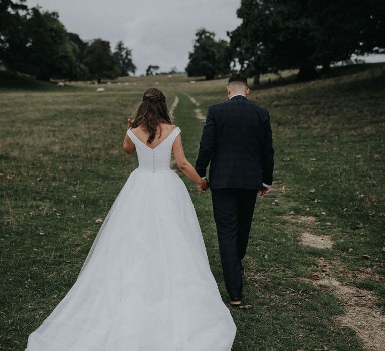 Bride and Groom Walking through the Countryside