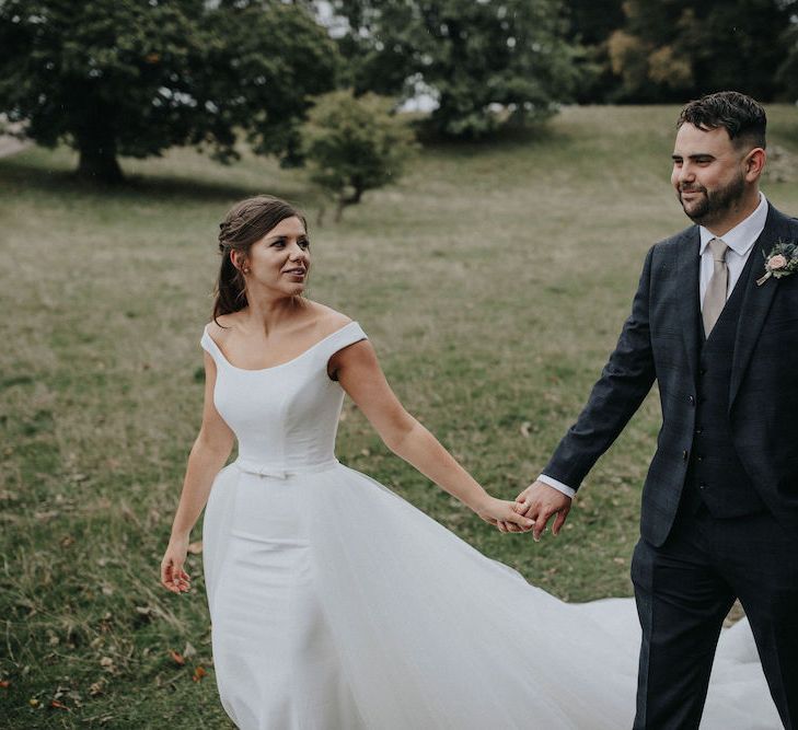 Bride and Groom Walking Through the Countryside Together