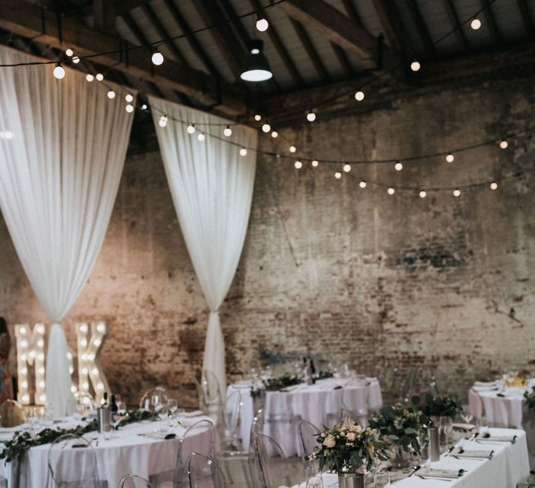 Wedding Reception Decor with Drapes, Marquee Letter Lights, Festoon Lights and Ghost Chairs