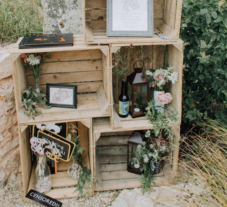 Wooden crate wedding decor with flowers and lanterns