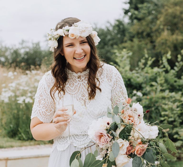 Bride in separates and flower crown smiling at Brickhouse Vineyard