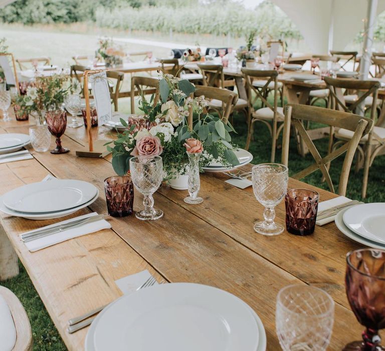 Wedding reception table decor with coloured goblets and flower centrepieces