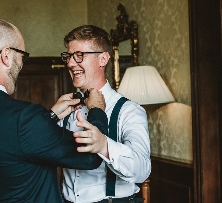 Groom Getting Ready in Tuxedo and Bow Tie