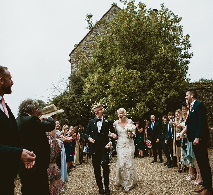 Confetti Moment with Bride in Vintage Style Tara Lauren Wedding Dress  and Groom in Black Tie