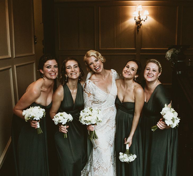 Bridal Party Portrait with Bridesmaids in Forest Green Wrap Dresses and Bride in Vintage Lace Dress