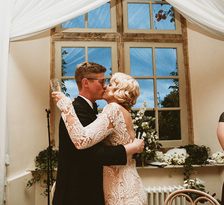 Bride in Vintage Lace Tara Lauren Wedding Dress and Groom in Tuxedo Kissing