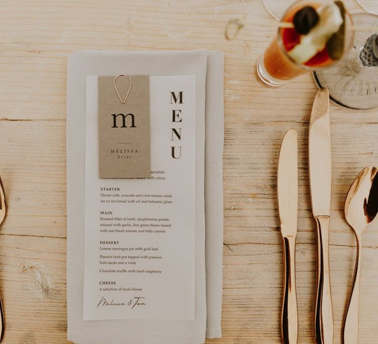 Wedding place setting and menu design with gold cutlery