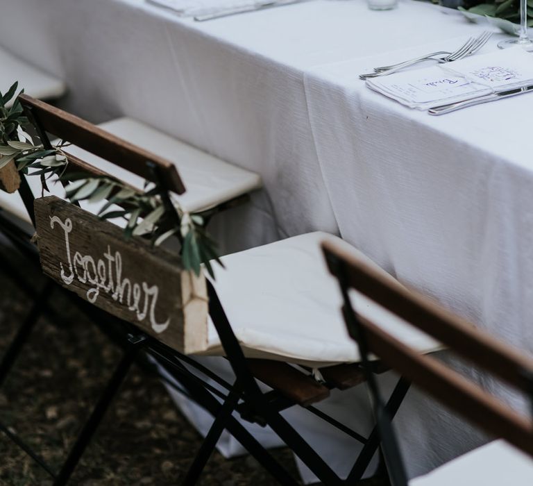 Wooden Together Chair Back Decor | Festoon Lit Outdoor Reception | Bohemian Destination Wedding at La Selva, Tuscany | Damien Milan Photography