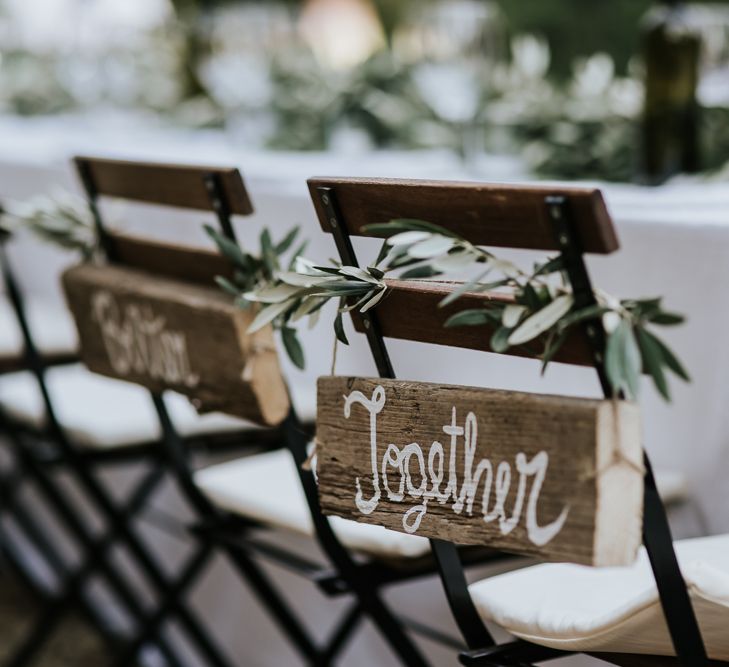 Wooden Together Chair Back Decor | Festoon Lit Outdoor Reception | Bohemian Destination Wedding at La Selva, Tuscany | Damien Milan Photography