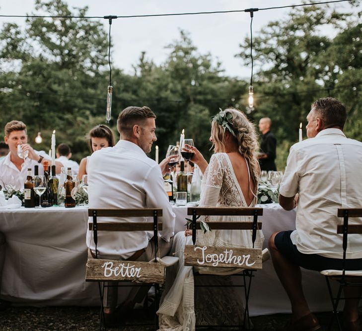 Wooden Chair Back Decor | Bride in Spell &amp; the Gypsy Collective Bell Sleeve Wedding Dress | Groom in Chino's &amp; Blazer | Outdoor Bohemian Destination Wedding at La Selva, Tuscany | Damien Milan Photography