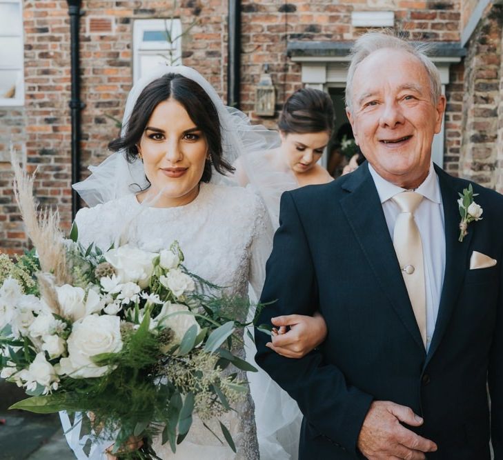 Bride walks to civil ceremony at Hornington Manor in Yorkshire