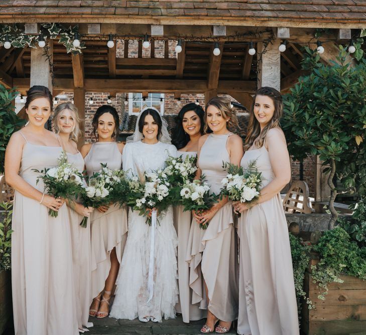 Bridesmaids in neutral bridesmaid dresses