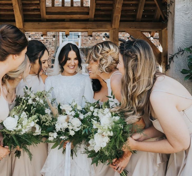 Bridesmaids in neutral bridesmaid dresses