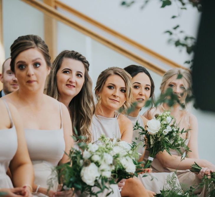 Bridesmaids watch on at civil wedding ceremony