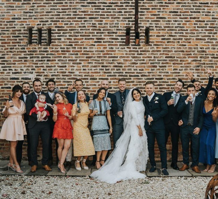 Bride in bespoke Emma Beaumont wedding dress with ruffle hem veil