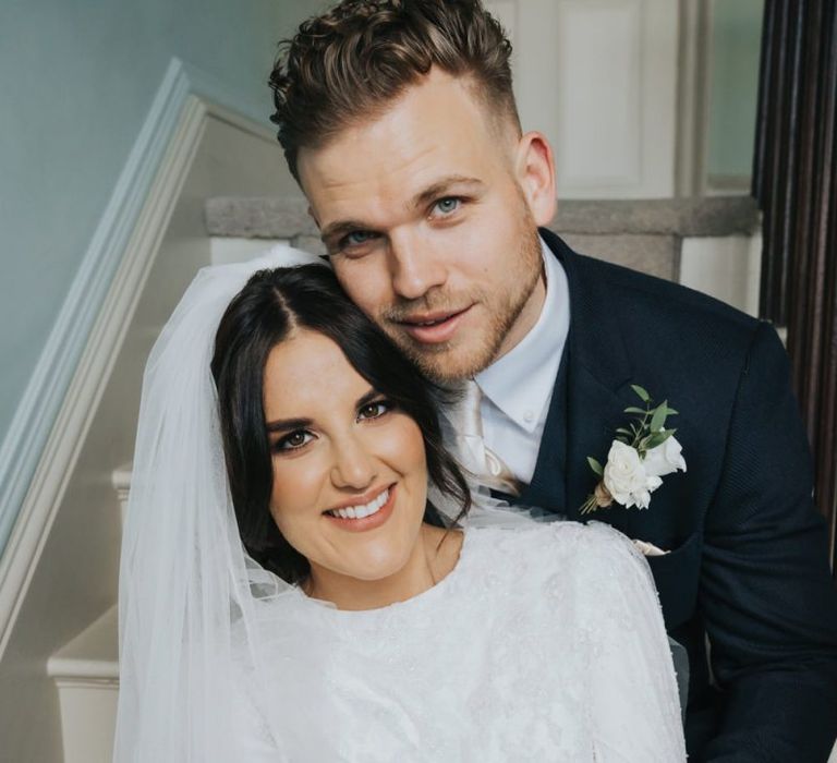 Bride and groom embracing on the stairs