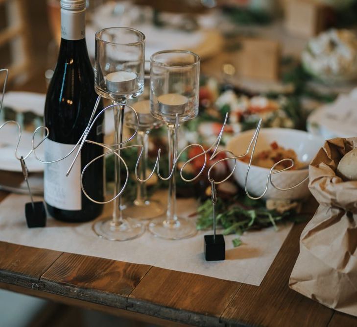 Sharing platters for guests at wedding breakfast with wire table names