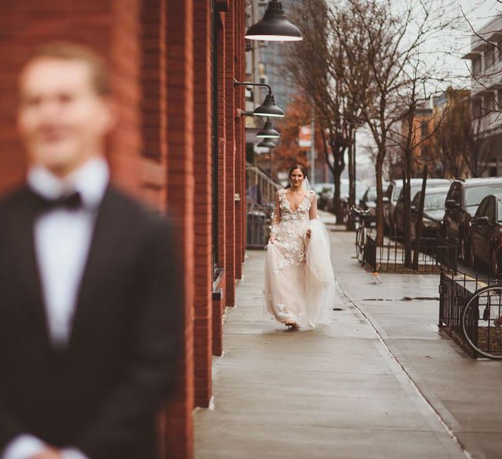 Bride in Marchesa gown walks towards groom for First Look