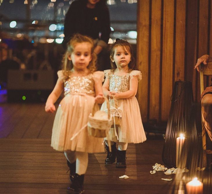 Cute flower girls walks down the aisle