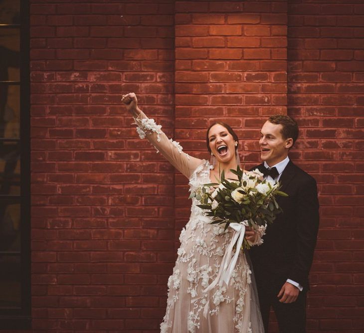 Bride in Marchesa bridal gown celebrates