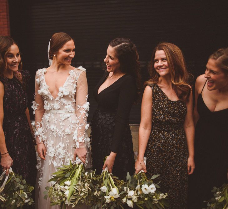 Bride in Marchesa bridal gown with bridesmaids in mismatched dresses