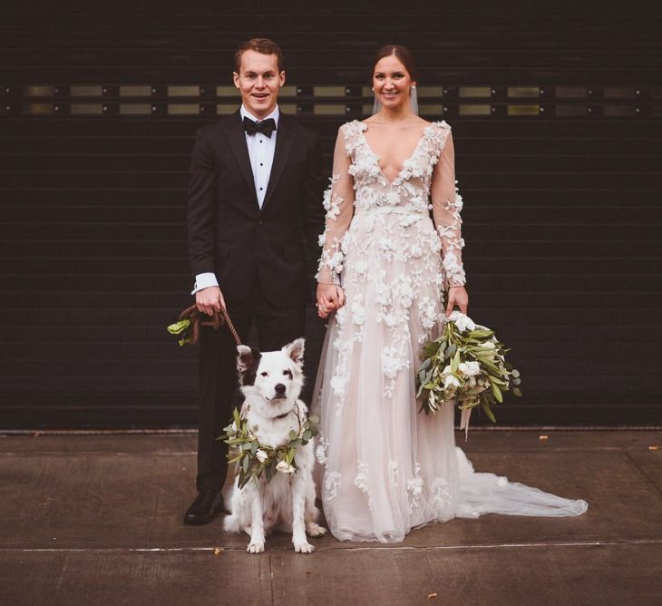 Bride and groom with family pet dog at their wedding in New York