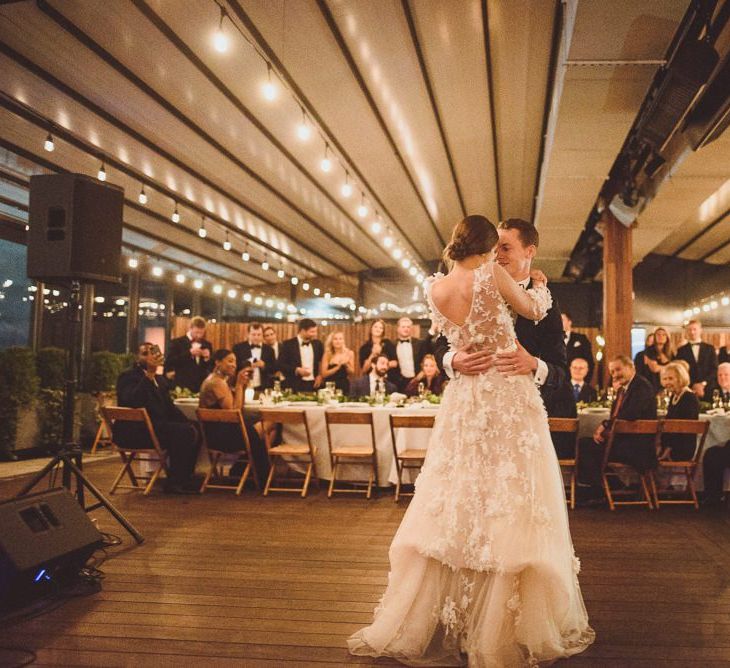 Bride in Marchesa wedding dress with groom during first dance