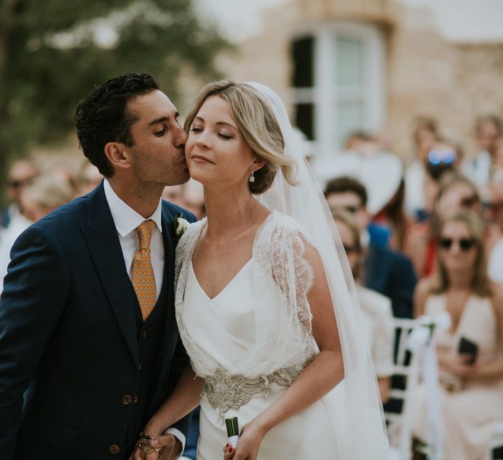 Outdoor Wedding Ceremony with Groom i Navy Blue Suit Greeting his Bride in Halfpenny Wedding Dress