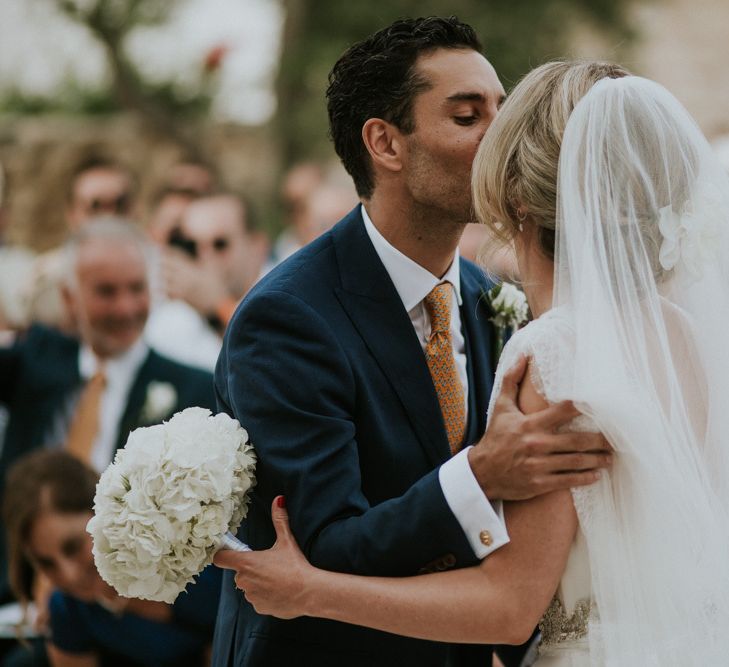 Outdoor Wedding Ceremony  with Bride and Groom Kissing